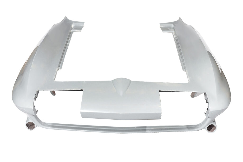 Chrome car bumper with grille and trim pieces.