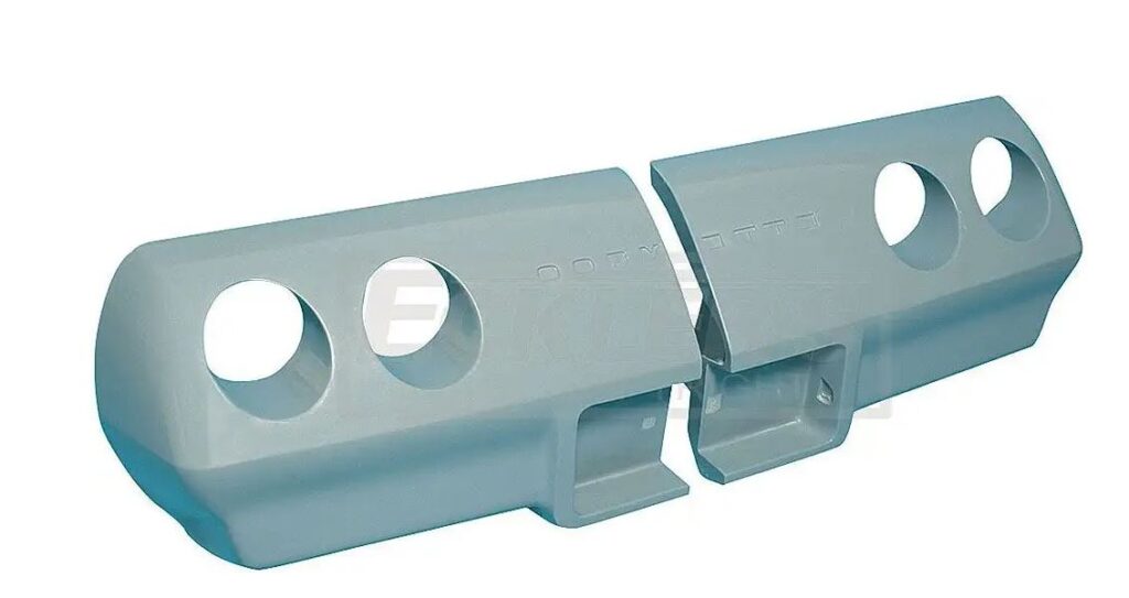 Close-up of a metallic mechanical component with holes and grooves.