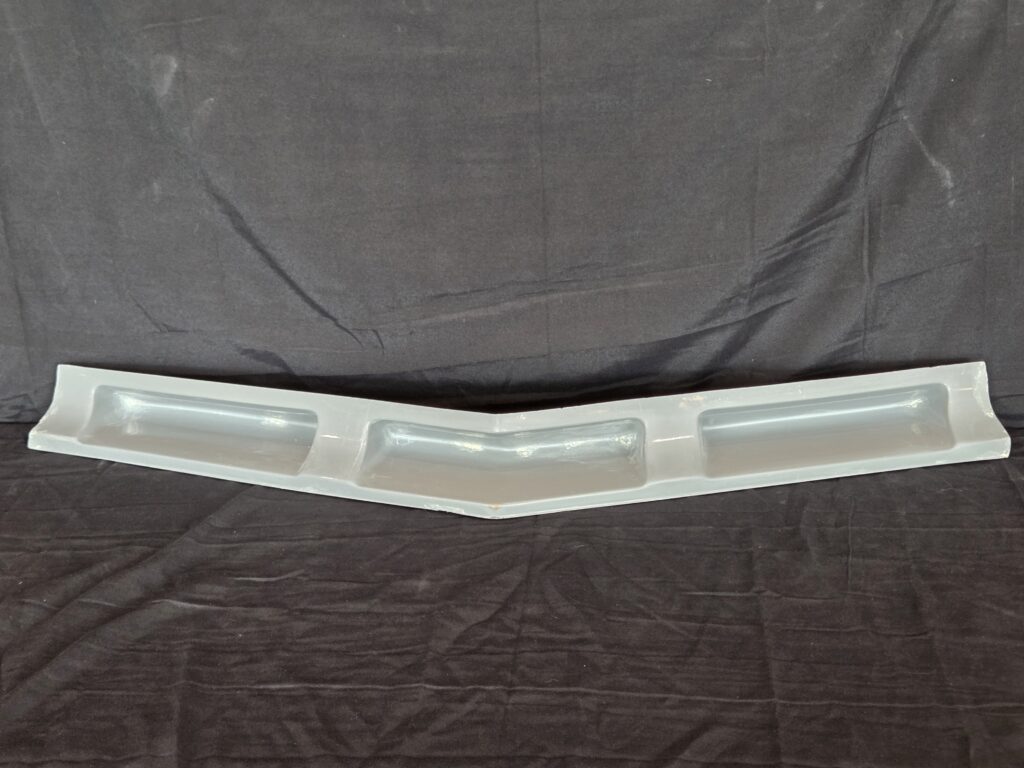 Gray fiberglass Corvette nose filler with three recesses