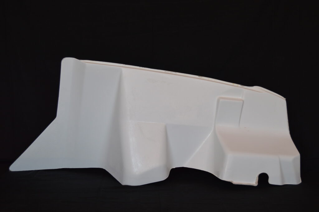 White molded plastic panel on black background