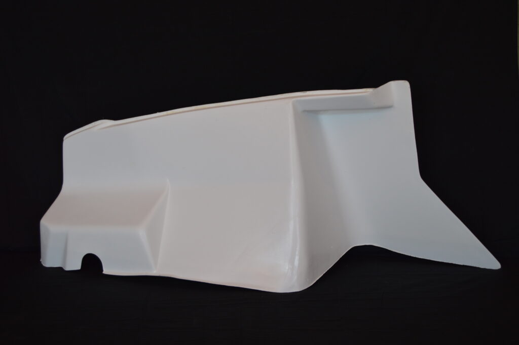 White molded plastic panel against black background