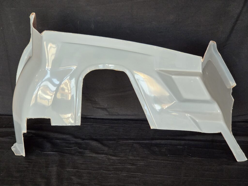 White car body panel against black backdrop