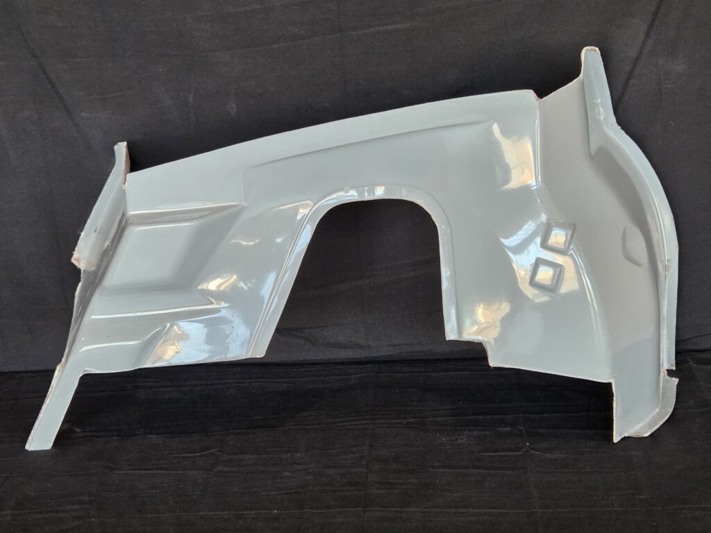Light gray car body panel on black background