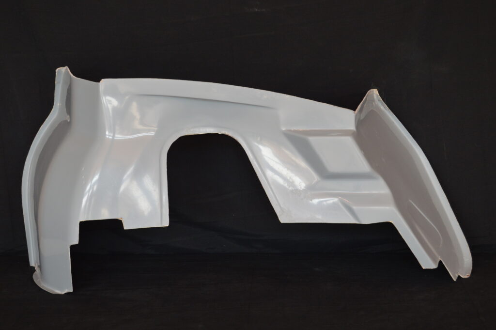 White car fender against black background