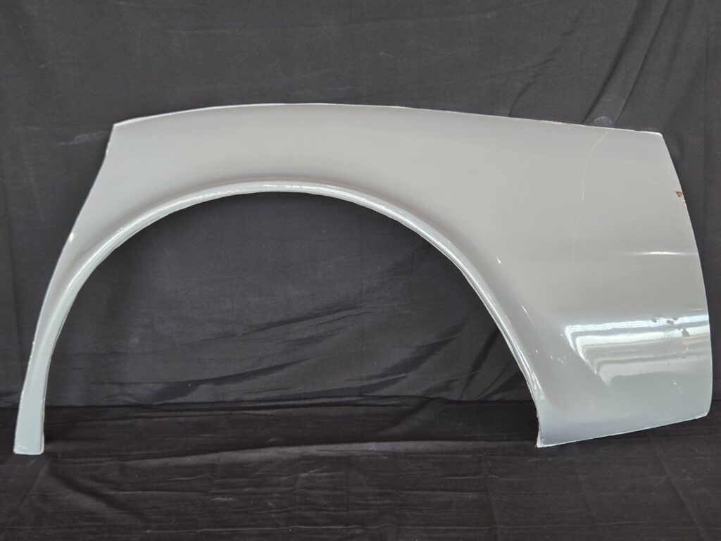 Gray car fender on black background