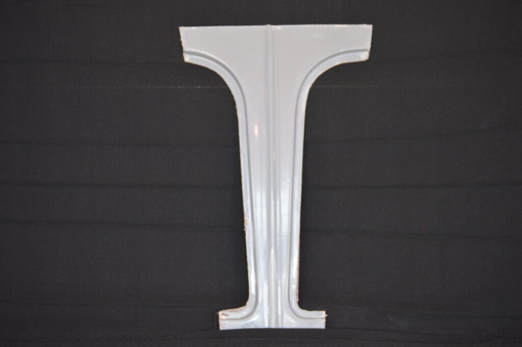 White decorative metal letter T on black
