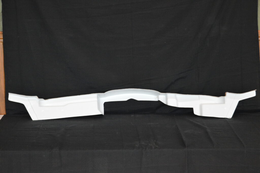 White car bumper against black background
