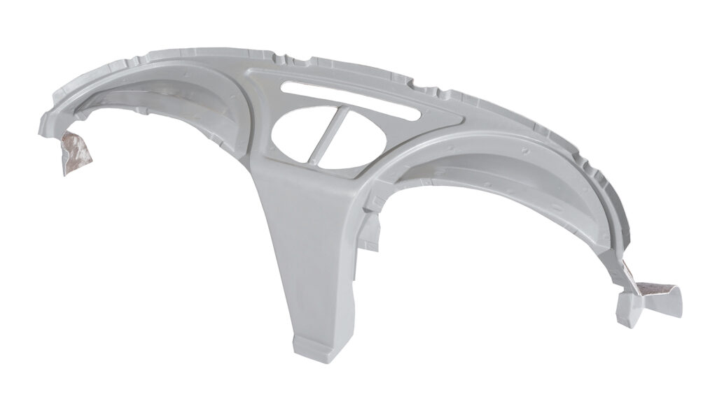 Silver metallic car fender with aerodynamic design and cutouts.