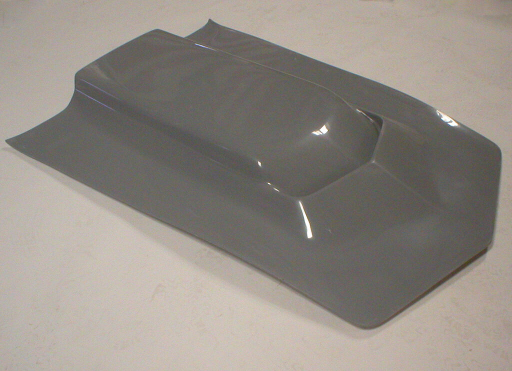 A gray plastic object with angular shapes and a smooth surface.