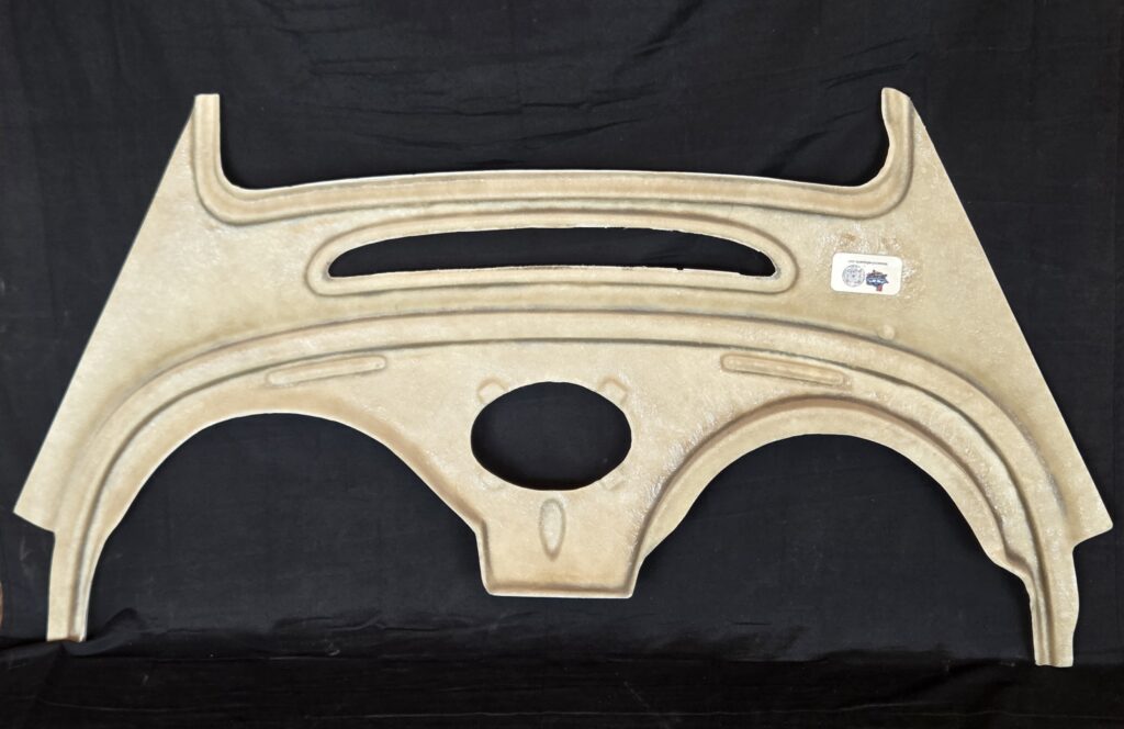 Beige molded automotive dashboard panel on black background