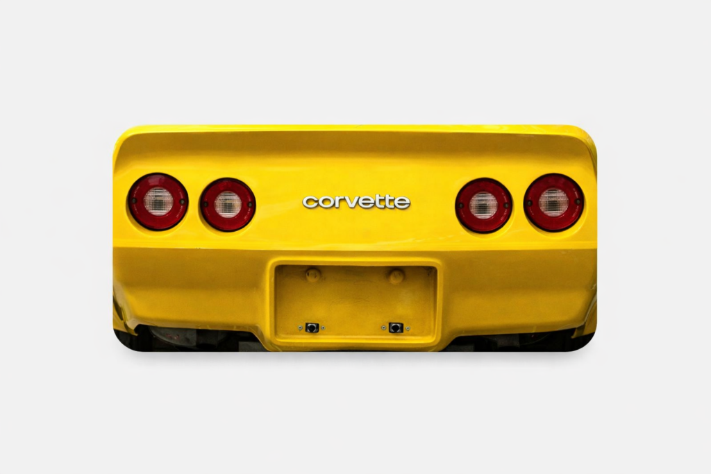 Rear of yellow Corvette with four taillights