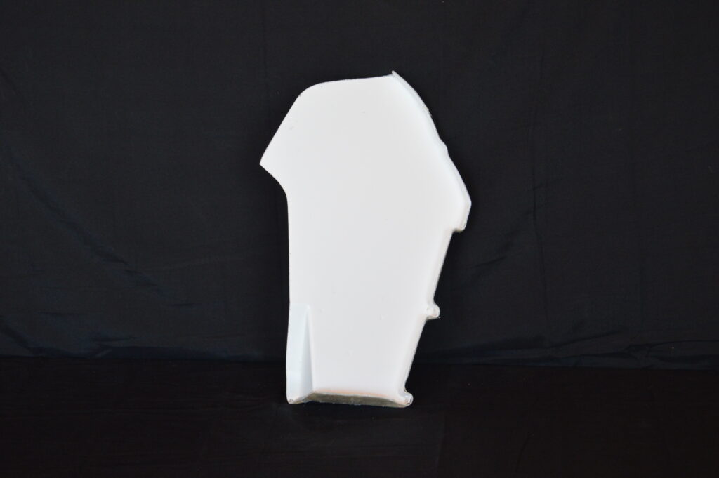 White abstract plaster piece on black background