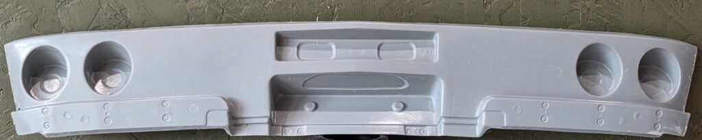 Gray molded panel with four cup holders