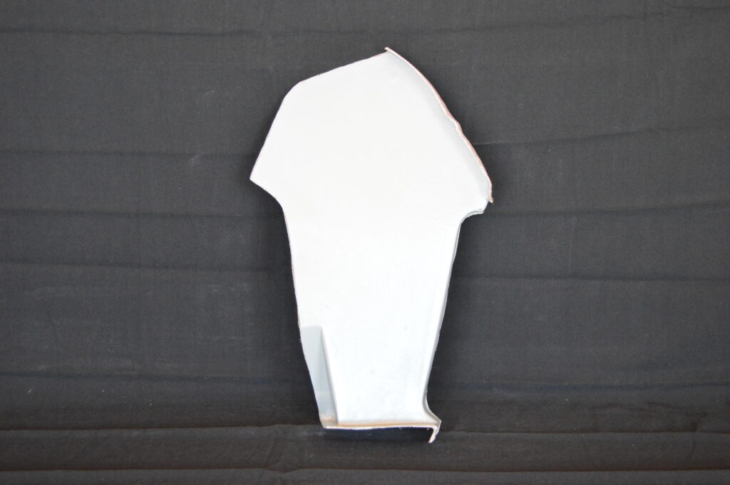 White abstract paper cutout on black backdrop