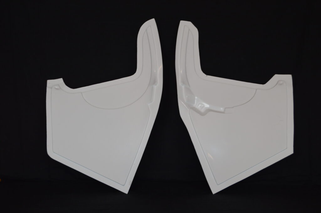 Two white plastic armor panels on black