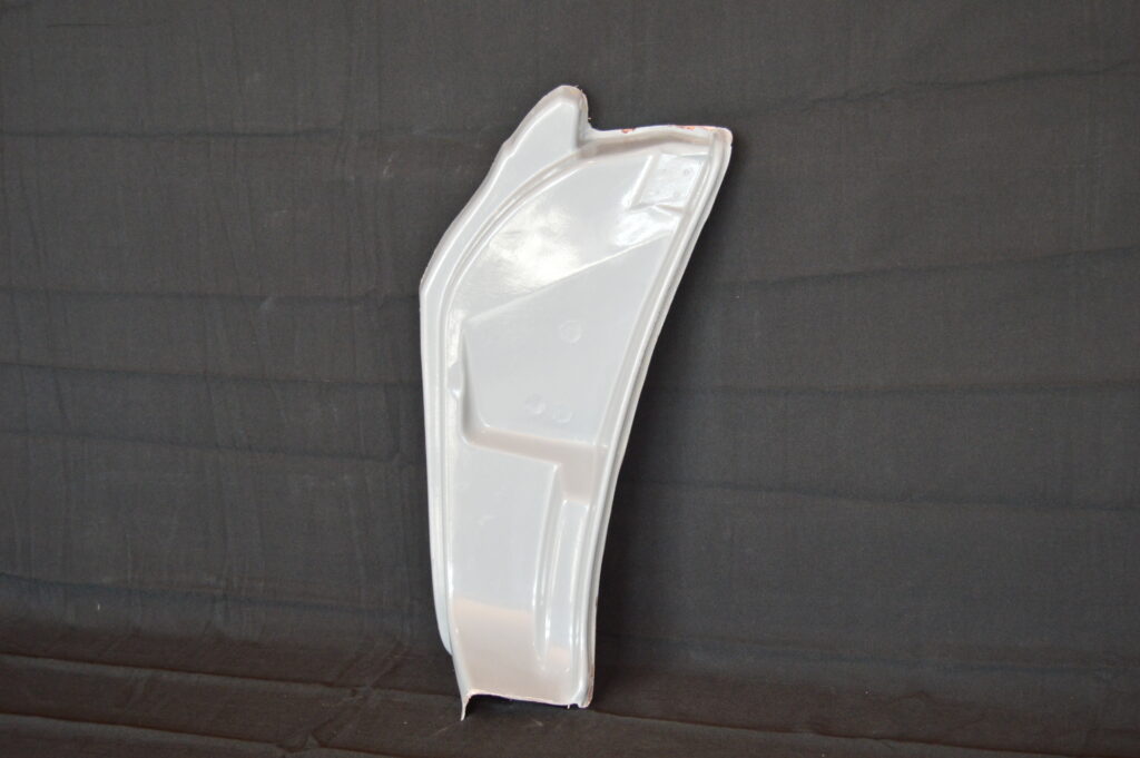 glossy white curved plastic car panel