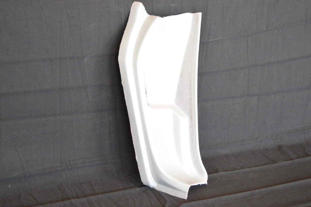 White foam packaging insert on dark fabric