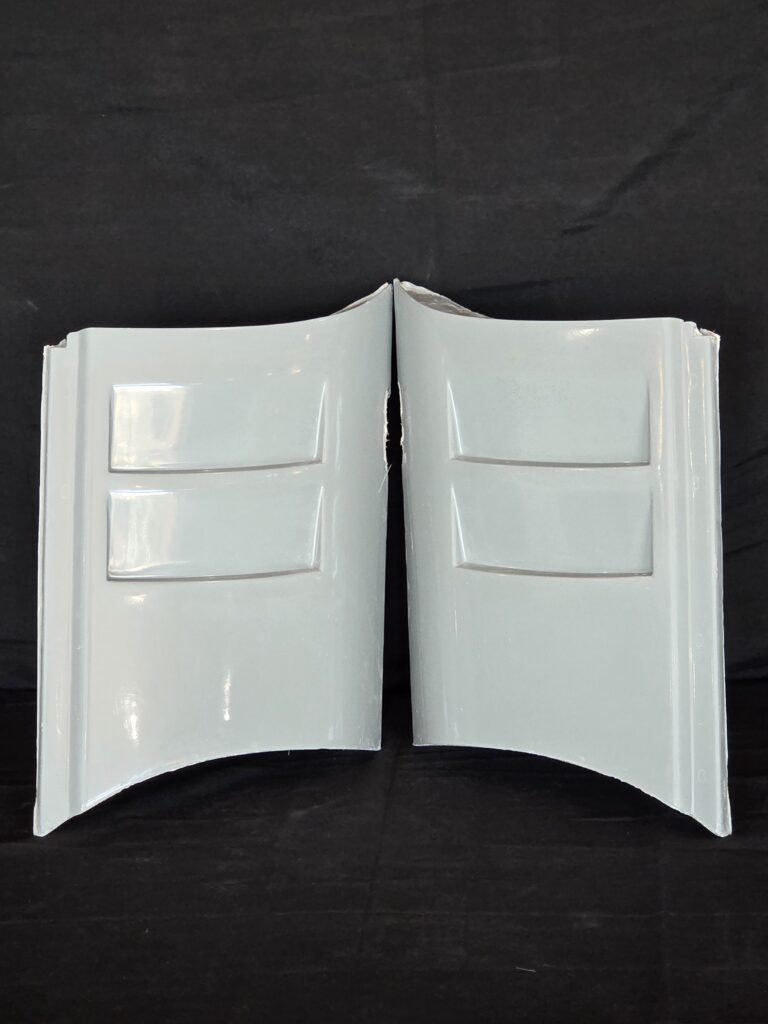 Two white curved panels against black background