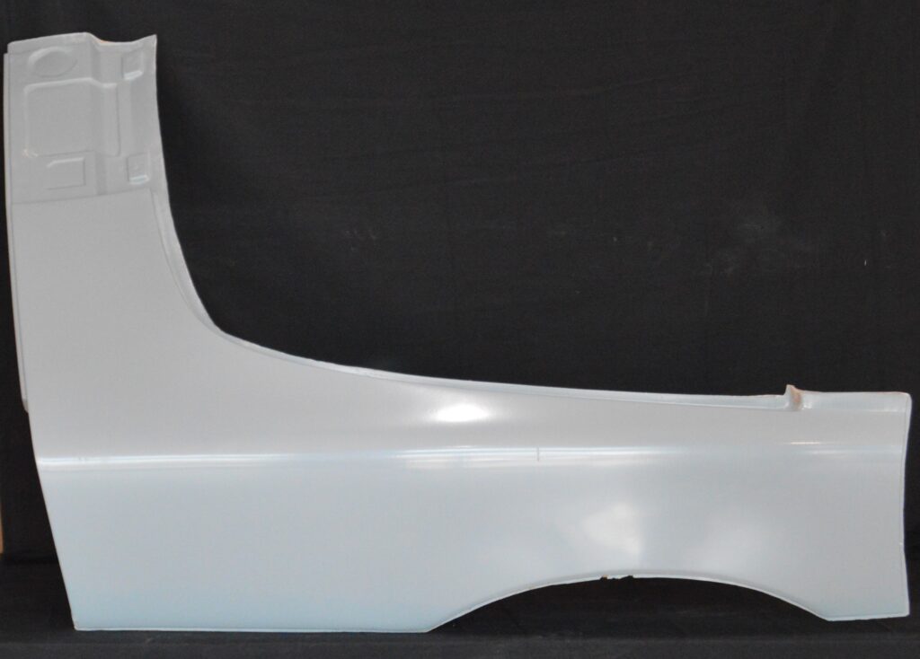 White car fender panel against black background