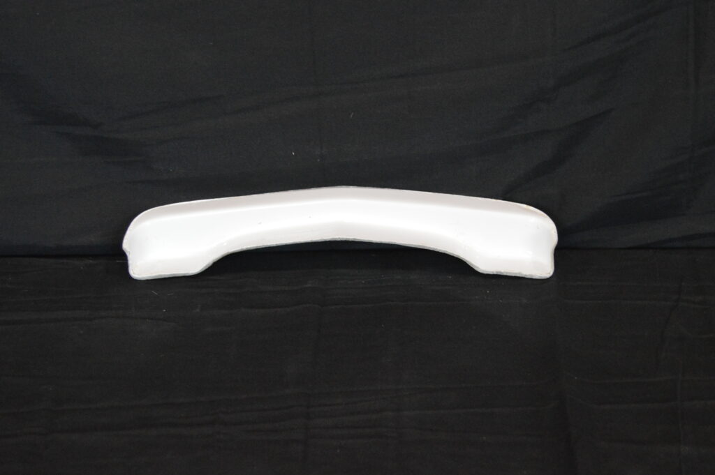 White curved plastic bumper on black background