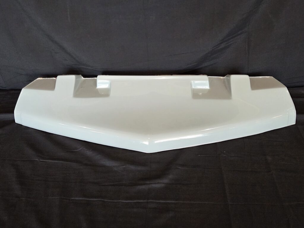 White automotive spoiler against black backdrop