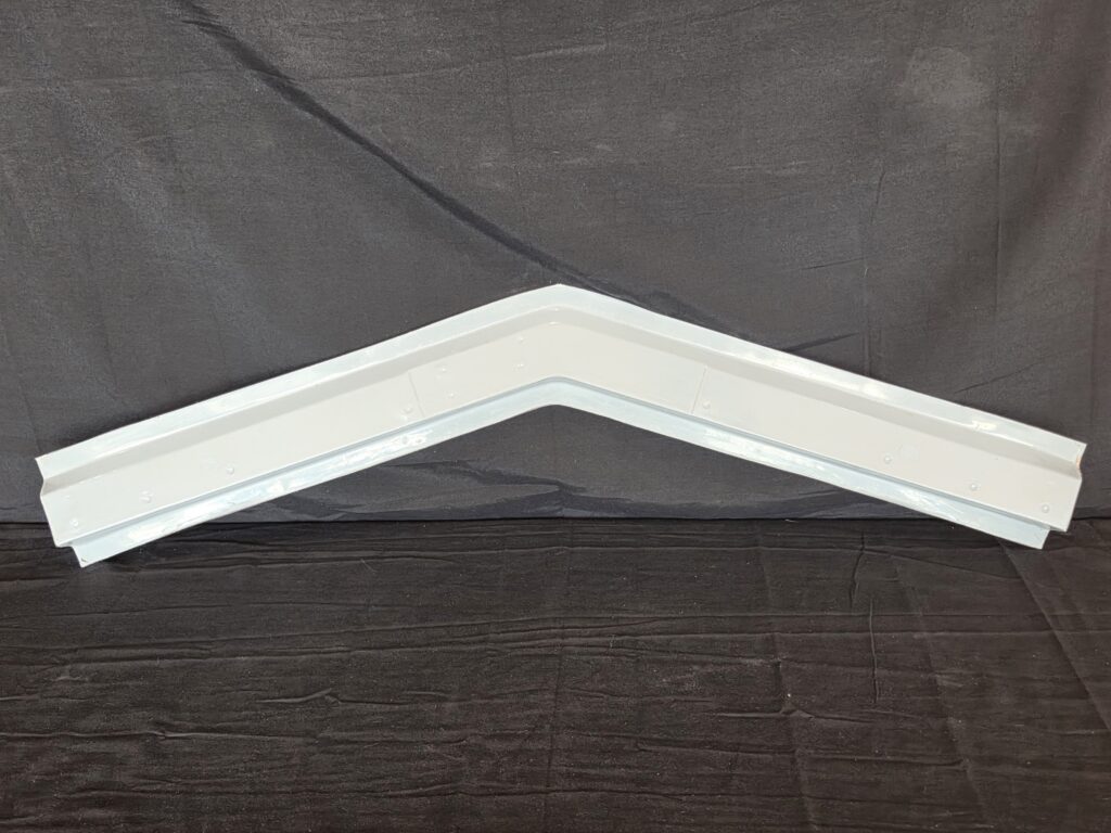 White V-shaped metal gutter section